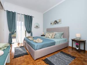 a bedroom with a blue bed and a couch at Corfu SKYLINE RESIDENT 360 in Corfu