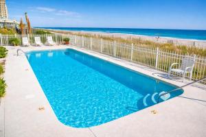 a swimming pool with the beach in the background at Ocean Shores 301 in North Myrtle Beach