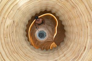 a man is standing in a wooden hat at Sanamane in Naoshima