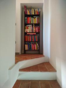 a book shelf filled with books in a room at Locazione del cavaliere in Fano