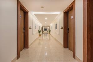 a hallway of a building with doors and tile floors at Treebo Premium Pine Tree Courtyard in Chennai