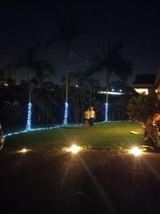 two people standing in a park at night with lights at Aztec Adress 133 Beckett Road, mixed shared accommodation in Brisbane +24 photos