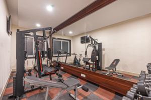 a gym with several treadmills and tread machines at Treebo Premium Pine Tree Courtyard in Chennai