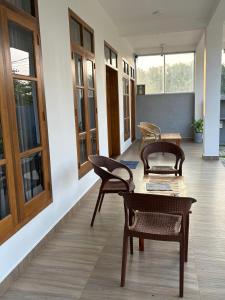 a room with chairs and a table and some windows at Crossing Royal in Mirissa