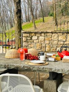 a table with food on top of a stone wall at La cantina dell'artista in Palazzago
