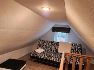 a couch in a living room with a window at Welcome to our Mouscron cocoon in Marcinelle