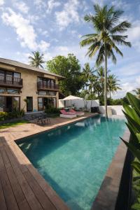 an image of a swimming pool in front of a house at Segara Hill Villa in Senggigi +38 photos