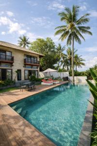 an image of a swimming pool in front of a house at Segara Hill Villa in Senggigi