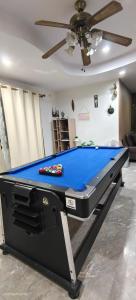 a pool table in a living room with a ceiling at AnChanPoolvilla อัญชัญ พลูวิลล่า in Pak Johng