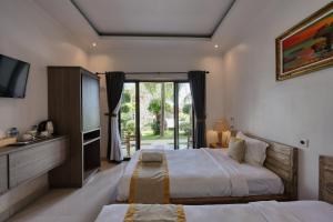 a large bedroom with two beds and a television at Kelingking Point in Nusa Penida +62 photos