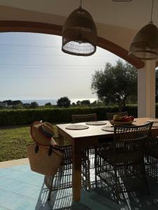 a dining table and chairs under a patio umbrella at Villa BellaVista in Belvedere Marittimo
