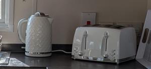 a kitchen counter with a toaster and a toaster at M6 Mallard Rise in Goodrington