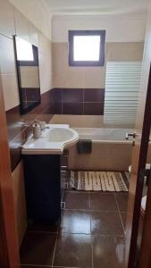 a bathroom with a sink and a bath tub at Sea View Andrade 3 Bedroom House in Gaula +64 photos
