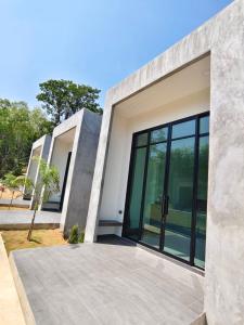 a house with large glass doors on the side of it at Pearlix Koh Mook in Ko Mook