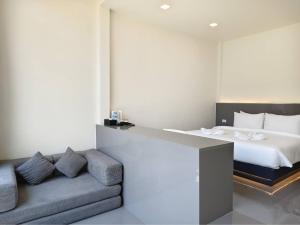 a bedroom with a bed and a couch and a bed at Pearlix Koh Mook in Ko Mook +7 photos