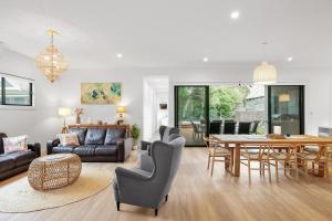 a living room with a table and a dining room at The Cape House in Cape Woolamai