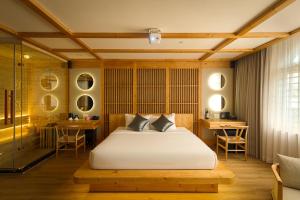 a bedroom with a bed and a table and chairs at Cupid Hotel 3 in Ho Chi Minh City