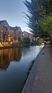a river with houses on the side of it at 4 Bancroft place in Stratford-upon-Avon