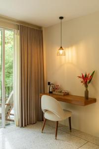 a desk with a white chair in a room at Tropical trails by wija house-unawatuna in Unawatuna