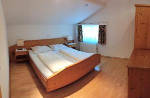 a bedroom with a large wooden bed in a room at Haus Luzia in Reith im Alpbachtal