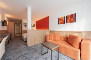 a living room with a couch and a table at Hotel Alpenland in Sankt Anton am Arlberg