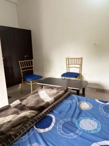 a room with a table and two chairs and a bed at Hotel Vishal in Jaipur