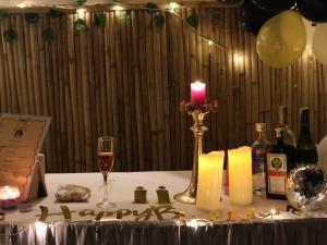 a table with a candle and a bottle of wine at Casa Musafir in Zirakpur +2 photos