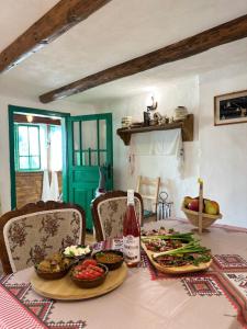 a table with plates of food on top of it at La Răscoala in Petrila