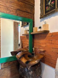 a bathroom with a wooden sink and a mirror at La Răscoala in Petrila +31 photos