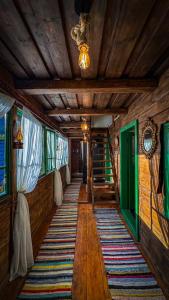 a hallway in a house with wooden walls and a ceiling at La Răscoala in Petrila