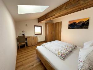 a bedroom with a bed and a desk at Leogang apartment with mountain views in Leogang