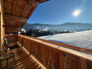 a balcony with a view of a snow covered mountain at Leogang apartment with mountain views in Leogang