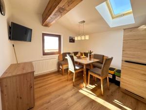 a kitchen and dining room with a table and chairs at Leogang apartment with mountain views in Leogang