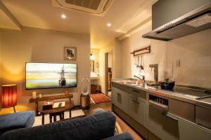 a kitchen with a couch and a table in a room at 云溪 表參道 in Tokyo
