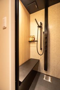 a shower stall with a bench in a bathroom at 云溪 表參道 in Tokyo +88 photos