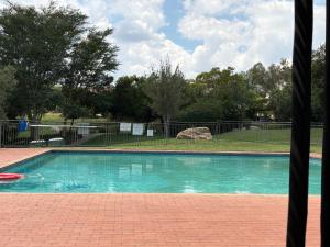 a swimming pool with a red frisbee in it at The golf estate gateway in Roodepoort