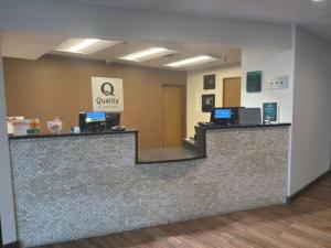 a lobby with a reception counter with two computers on it at Quality Inn & Suites Colby in Colby