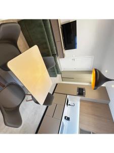 an office with a desk with a lamp and chairs at comfy home in Padenghe sul Garda