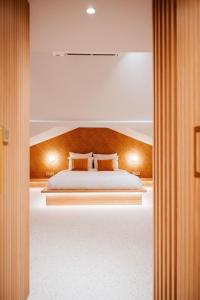 a bedroom with a bed with two pillows on it at Héritage Collection - Suites in Verviers
