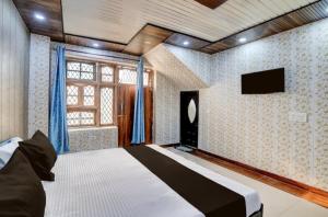 a bedroom with a bed and a television in it at Nice hotel in Faridabad