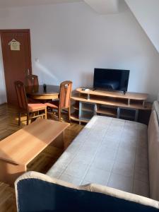 a living room with a couch and a table and chairs at Guest House Sani in Skopje
