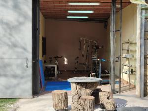 a gym with a table and some logs at Casa rural Ca l'Antón in Sant Miquel de Campmajor