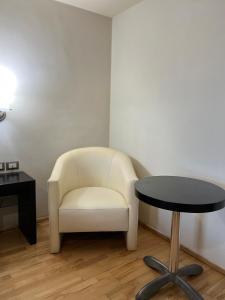 a white chair and a table in a room at Hotel Granada in Puebla