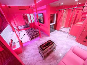 an overhead view of a room with pink lighting at Fire Hotel Nw in Saitama