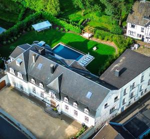 an aerial view of a large house with a yard at Héritage Collection - Suites in Verviers