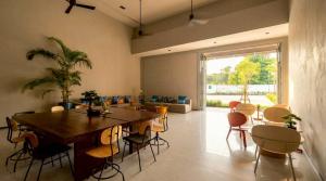 a dining room with a large wooden table and chairs at Beehive Boutique Hotel Phuket in Phuket