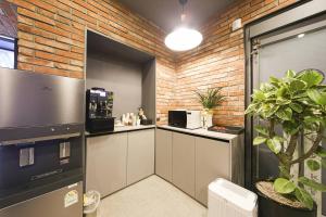 a kitchen with a counter and a brick wall at ZaZa HOTEL in Bucheon