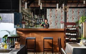 a woman standing behind a bar in a restaurant at Harmony Indochine d'Angkor in Siem Reap +43 photos