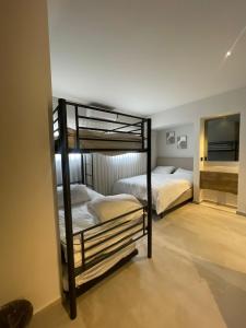 two bunk beds in a room with a mirror at הוד והדר in Netanya