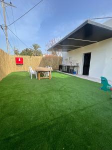a backyard with a picnic table and green grass at הוד והדר in Netanya